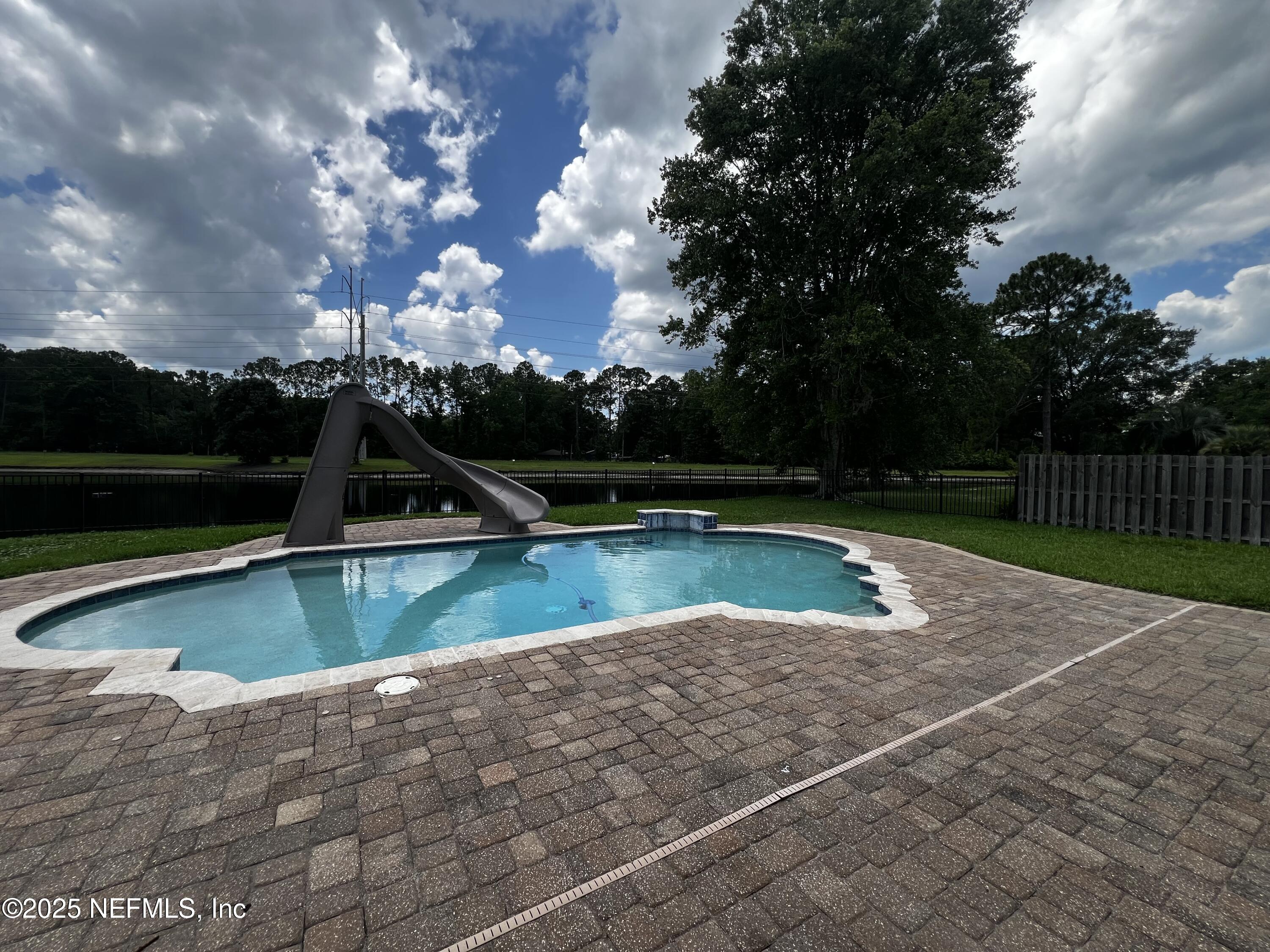 10310 Hamlet Glen Drive Jacksonville, FL 32221 - Photo 31 of 33 a view of a swimming pool with a yard
