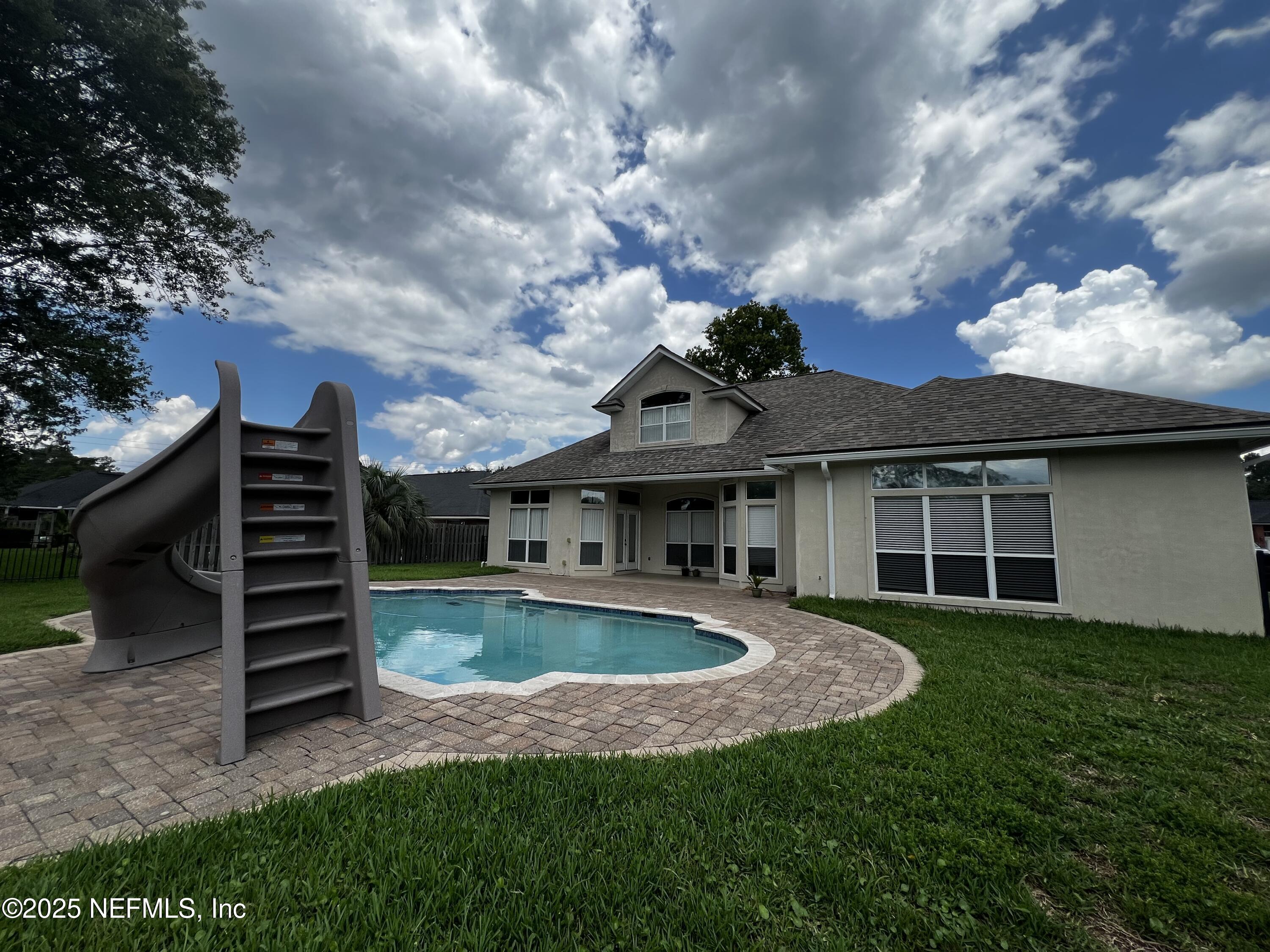 10310 Hamlet Glen Drive Jacksonville, FL 32221 - Photo 33 of 33 a view of a house with a sink and a yard