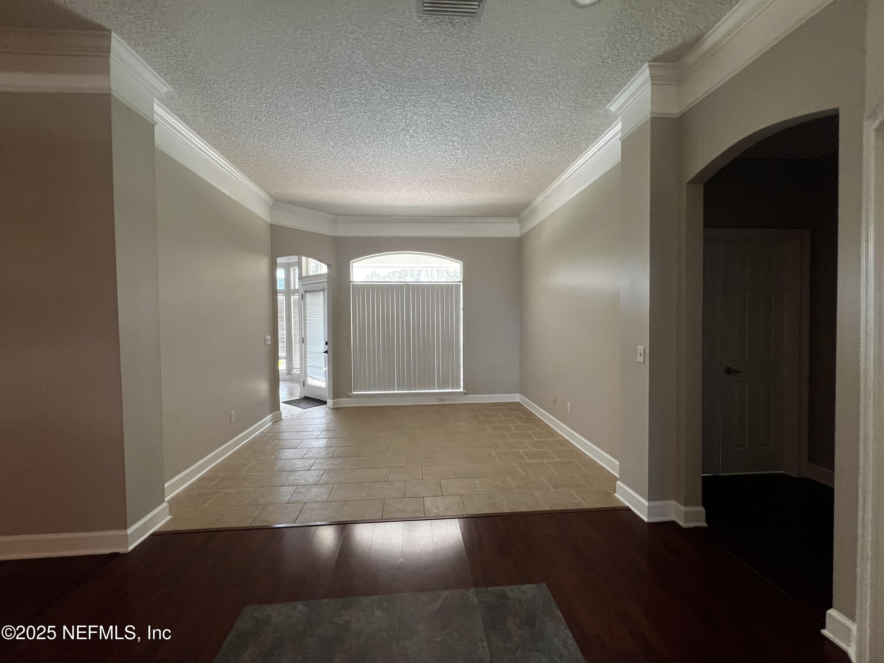 10310 Hamlet Glen Drive Jacksonville, FL 32221 - Photo 9 of 33 an empty room with wooden floor and closet