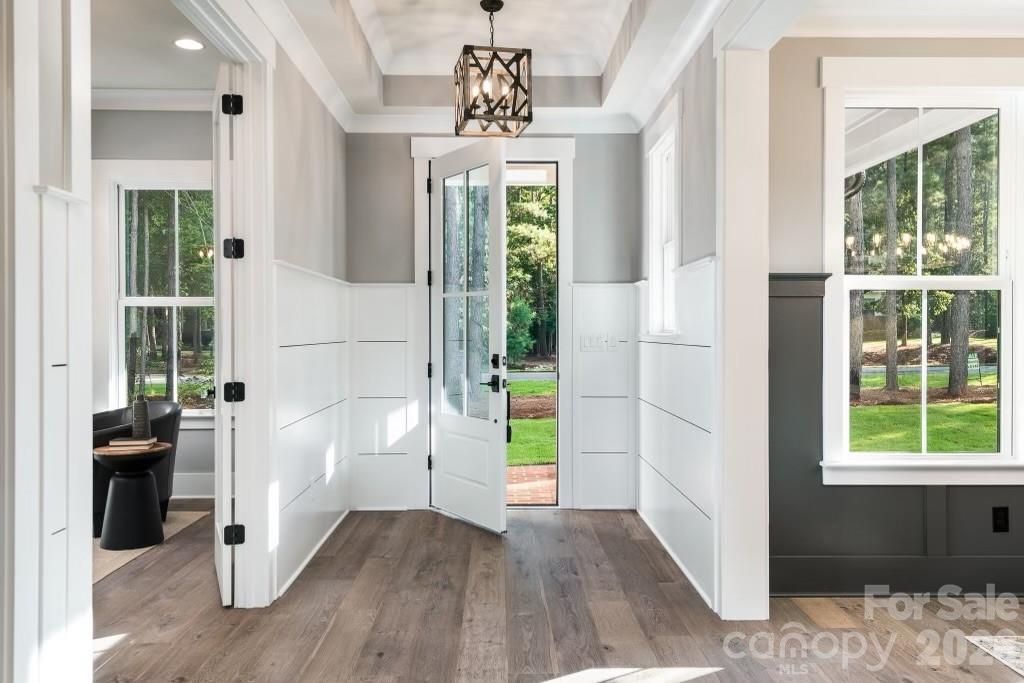 116 Silver Falls Road Troutman, NC 28166 - Photo 5 of 46 a view of an entryway with wooden floor and windows