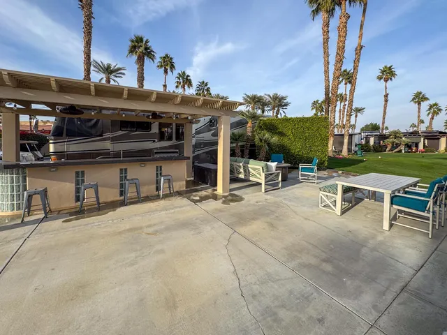 a view of a patio with swimming pool table and chairs