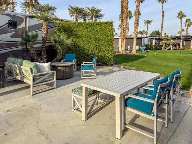 a view of a patio with table and chairs and potted plants