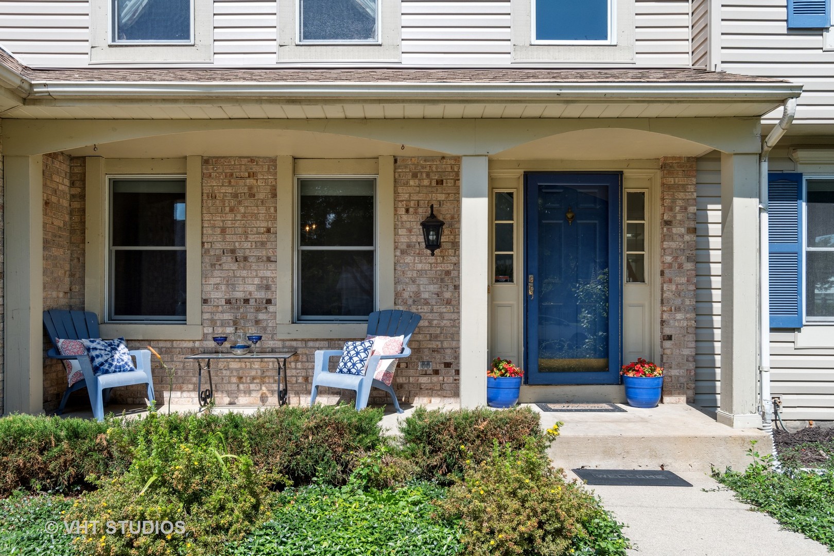 2780 Carriage Way Aurora, IL 60504 - Photo 2 of 19 front view of a brick building with potted plants