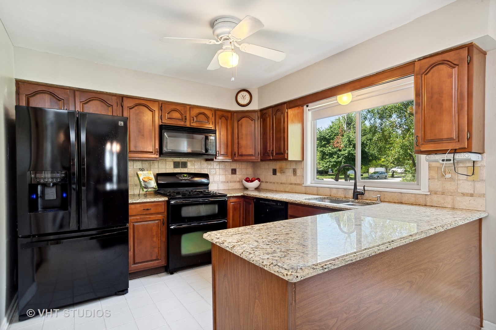 2780 Carriage Way Aurora, IL 60504 - Photo 5 of 19 a kitchen with stainless steel appliances granite countertop a sink a stove and a refrigerator