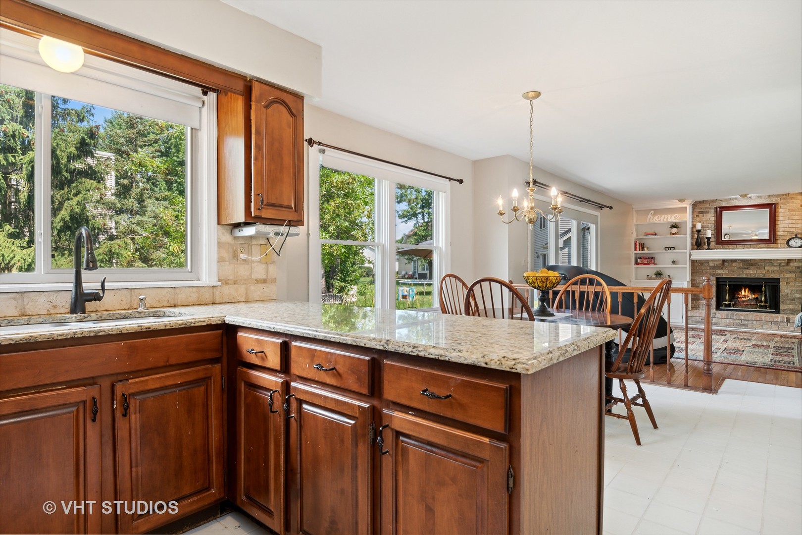 2780 Carriage Way Aurora, IL 60504 - Photo 6 of 19 a kitchen with granite countertop a sink a counter top space and living room view