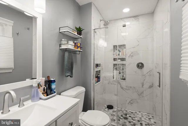 a bathroom with a sink toilet and shower