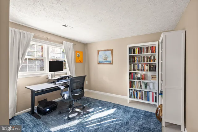 a living room with furniture a large window and a fireplace