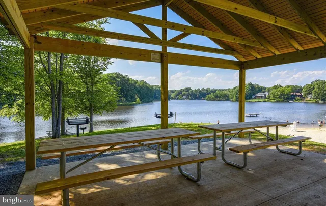 a kitchen with stainless steel appliances granite countertop a refrigerator a stove and a sink