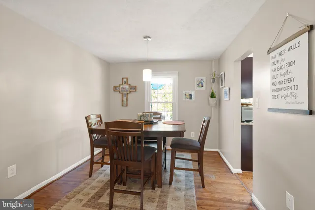 a bedroom with a bed a dresser next to a window
