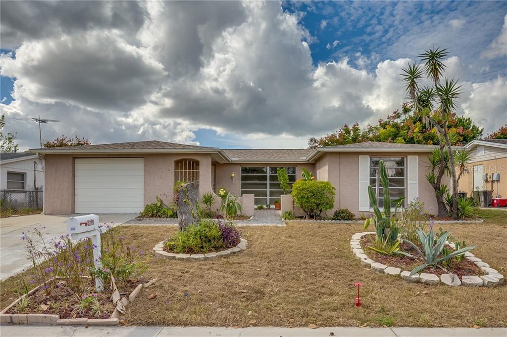 9605 Rainbow Lane Port Richey, FL 34668 - Photo 1 of 1 front view of a house with a yard