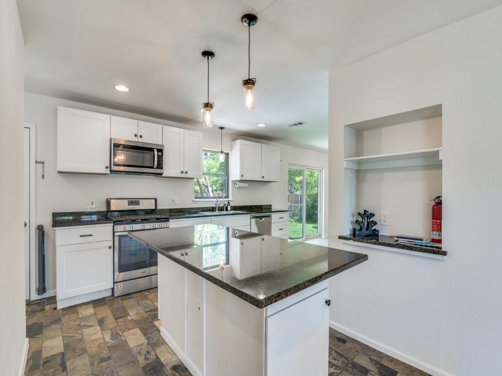 2315 Inadale Avenue Dallas, TX 75228 - Photo 13 of 36 a kitchen with a sink a counter top space cabinets and stainless steel appliances