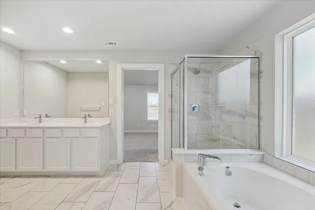 a bathroom with a bathtub a sink and a shower
