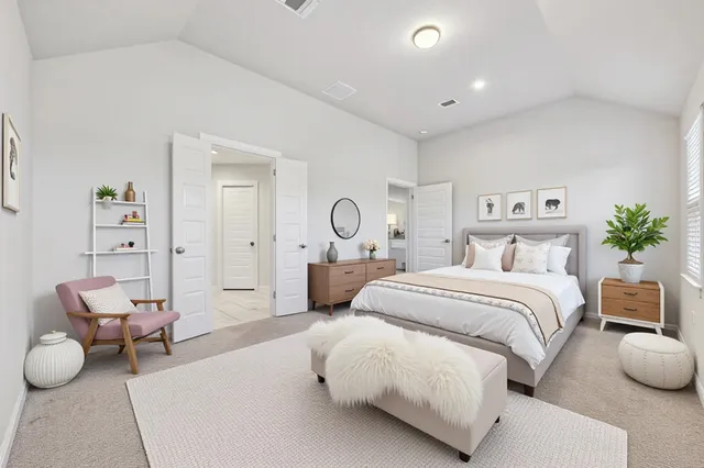 a spacious bedroom with a bed and furniture