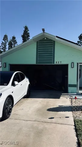 a front view of a house with parking space