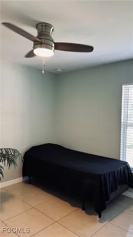 a bedroom with a bed and ceiling fan