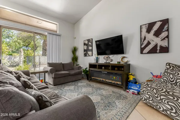 a living room with furniture and a flat screen tv