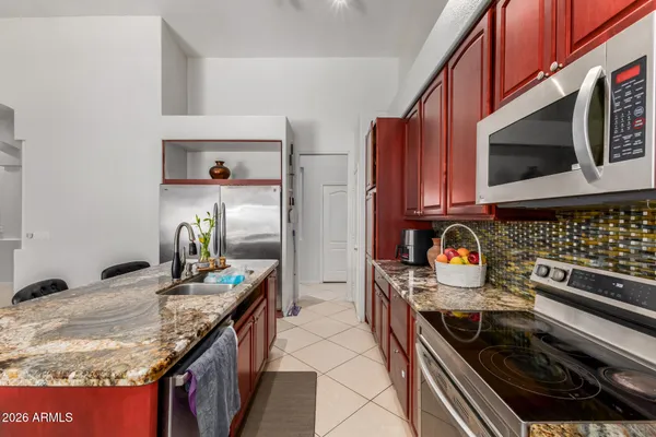 a kitchen with stainless steel appliances granite countertop a stove and a microwave