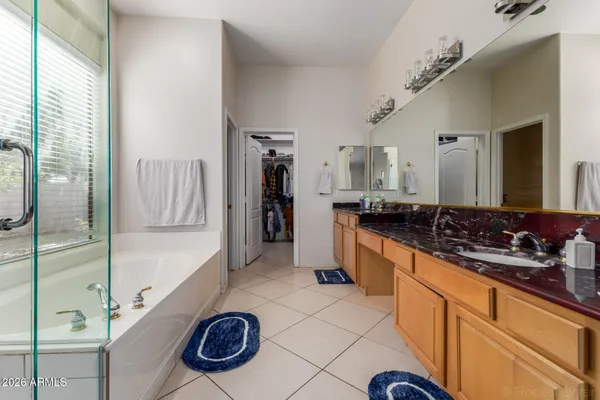 a large bathroom with a double vanity sink a mirror and a shower