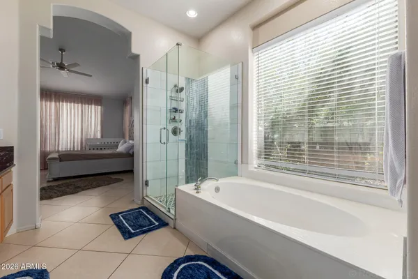a bathroom with a tub shower and sink