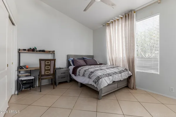a bedroom with a bed and a window