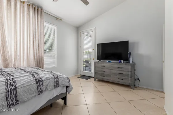 a room that has a dresser and a flat screen tv