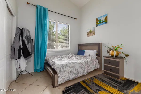 a bedroom with a bed and a window