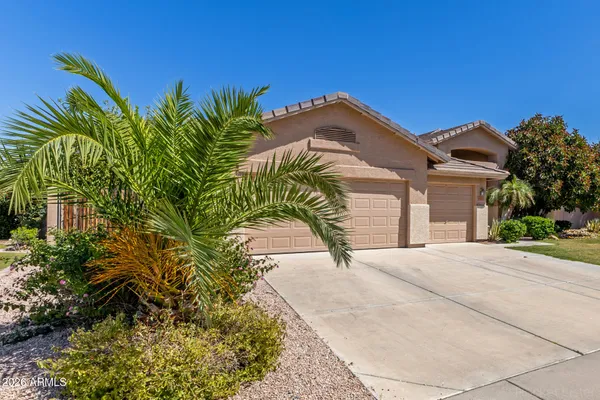 a view of a house with a small yard and potted plants