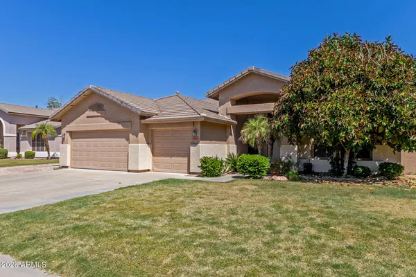 a front view of a house with a yard and garage
