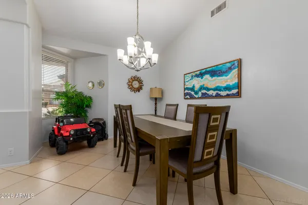 a view of a dining room with furniture and chandelier
