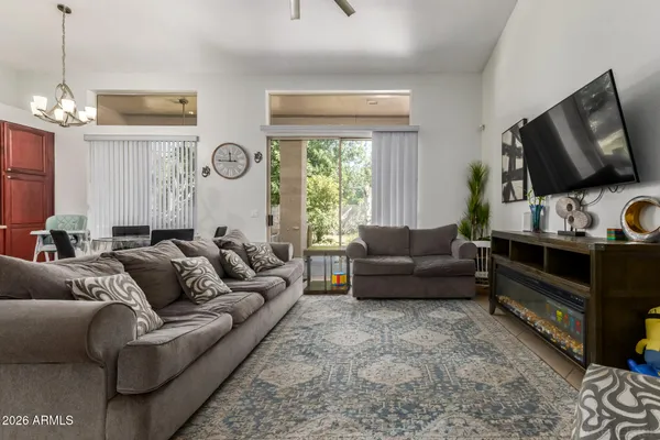 a living room with furniture fireplace and flat screen tv