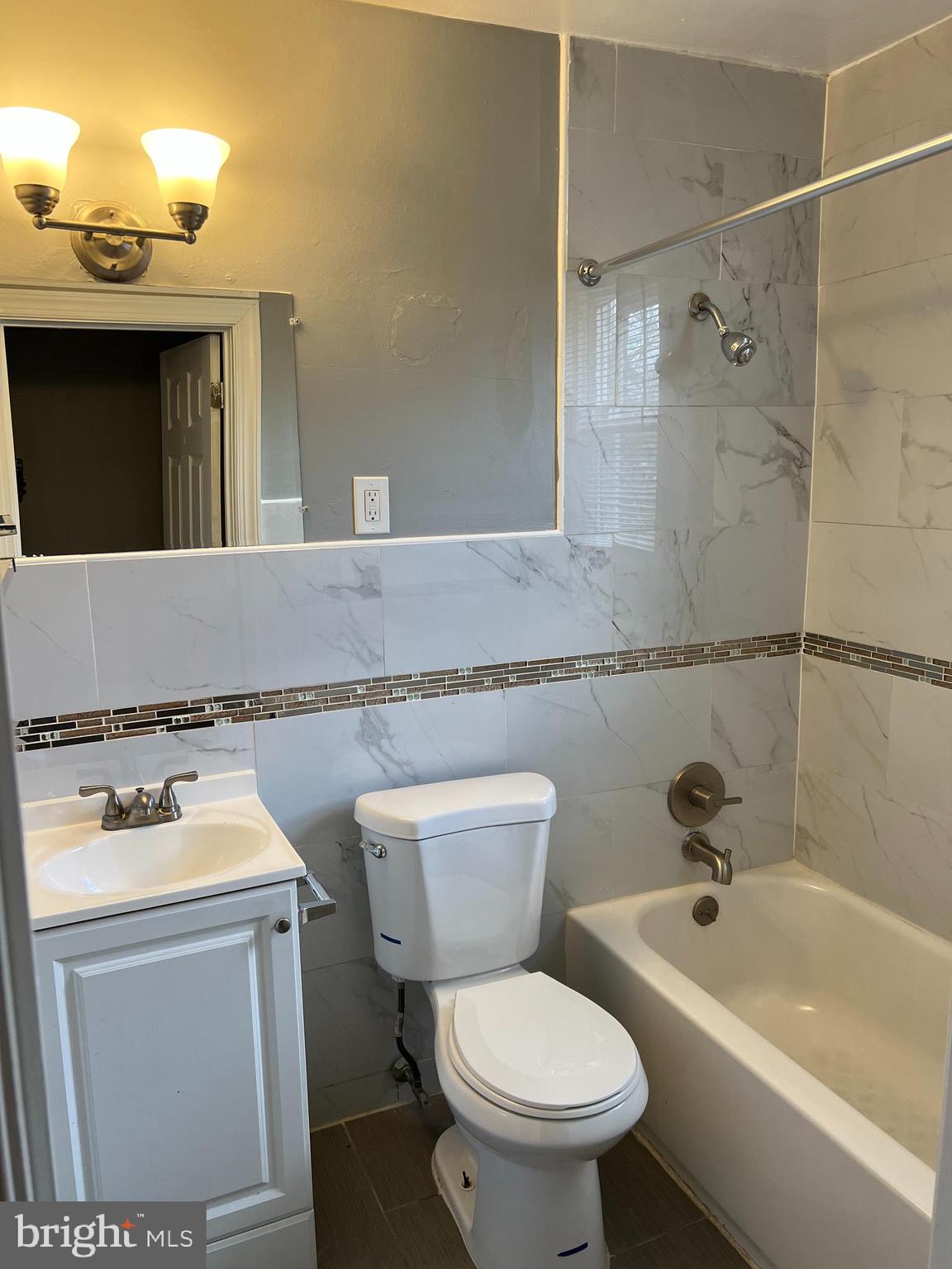 1121 Gleneagle Road Baltimore, MD 21239 - Photo 12 of 17 a bathroom with a sink toilet and shower