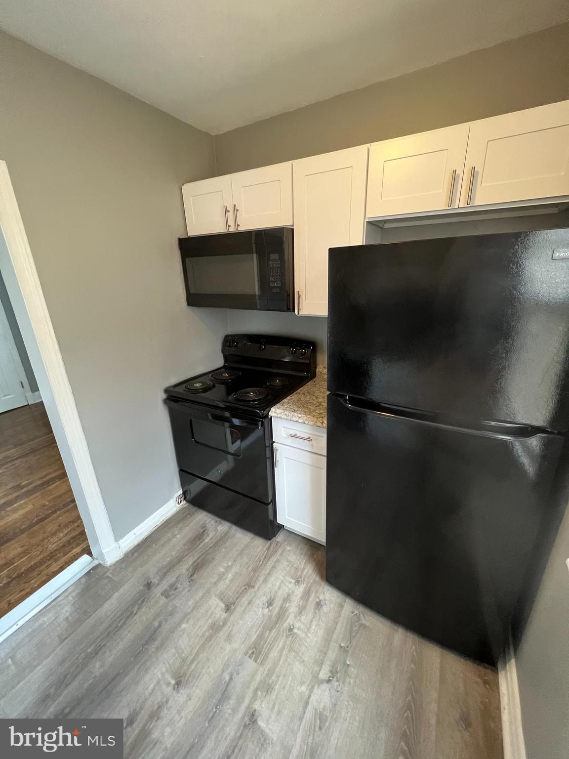1121 Gleneagle Road Baltimore, MD 21239 - Photo 5 of 17 a kitchen with a refrigerator and a stove