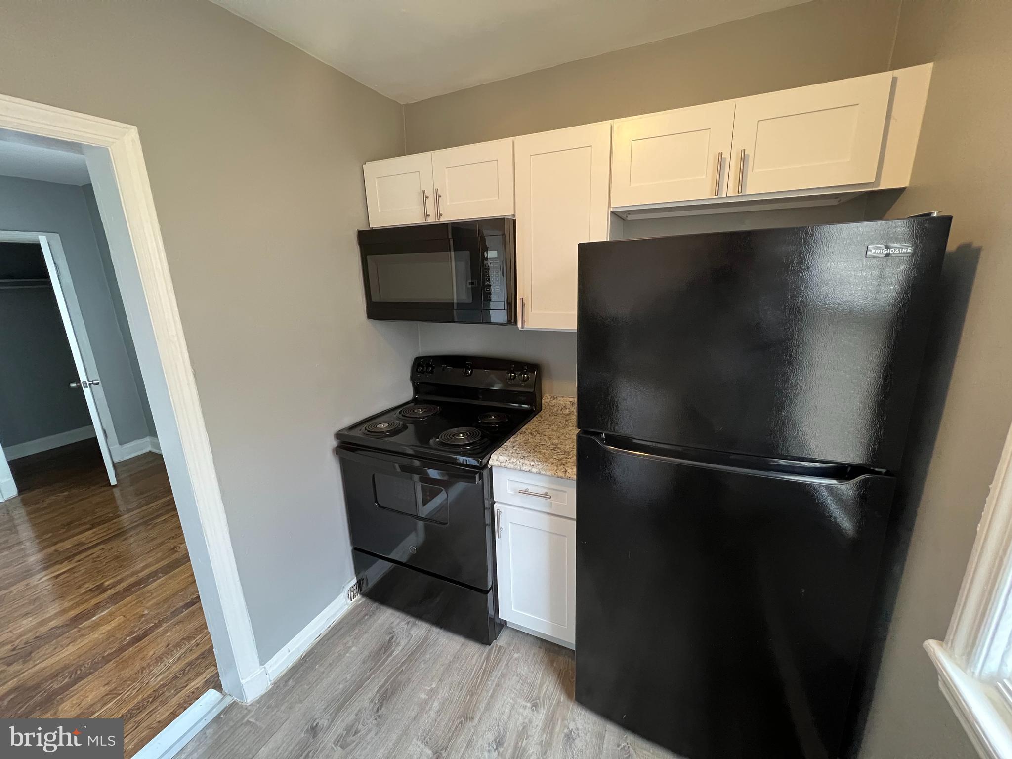 1121 Gleneagle Road Baltimore, MD 21239 - Photo 6 of 17 a kitchen with a refrigerator stove and a sink