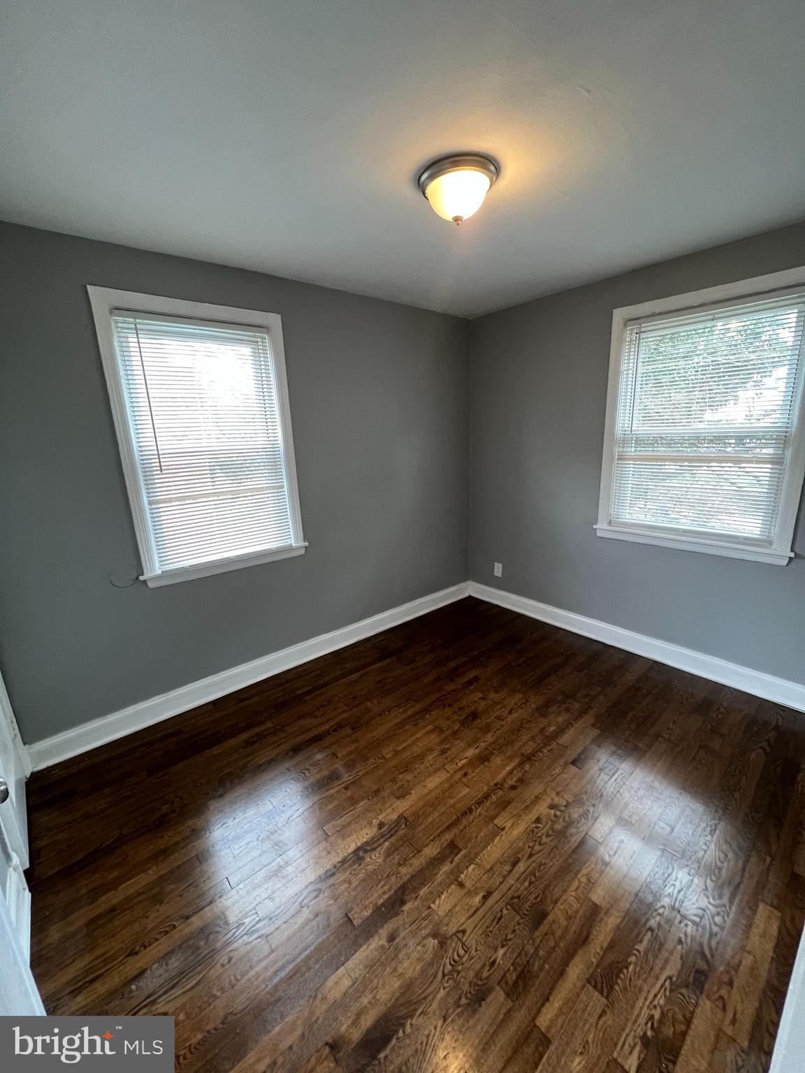 1121 Gleneagle Road Baltimore, MD 21239 - Photo 9 of 17 a view of an empty room with wooden floor and a window