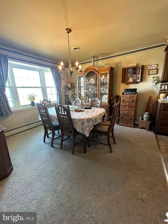 a dining room with furniture and chandelier