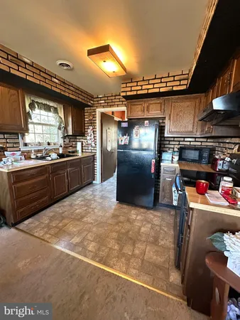 a kitchen with refrigerator and window