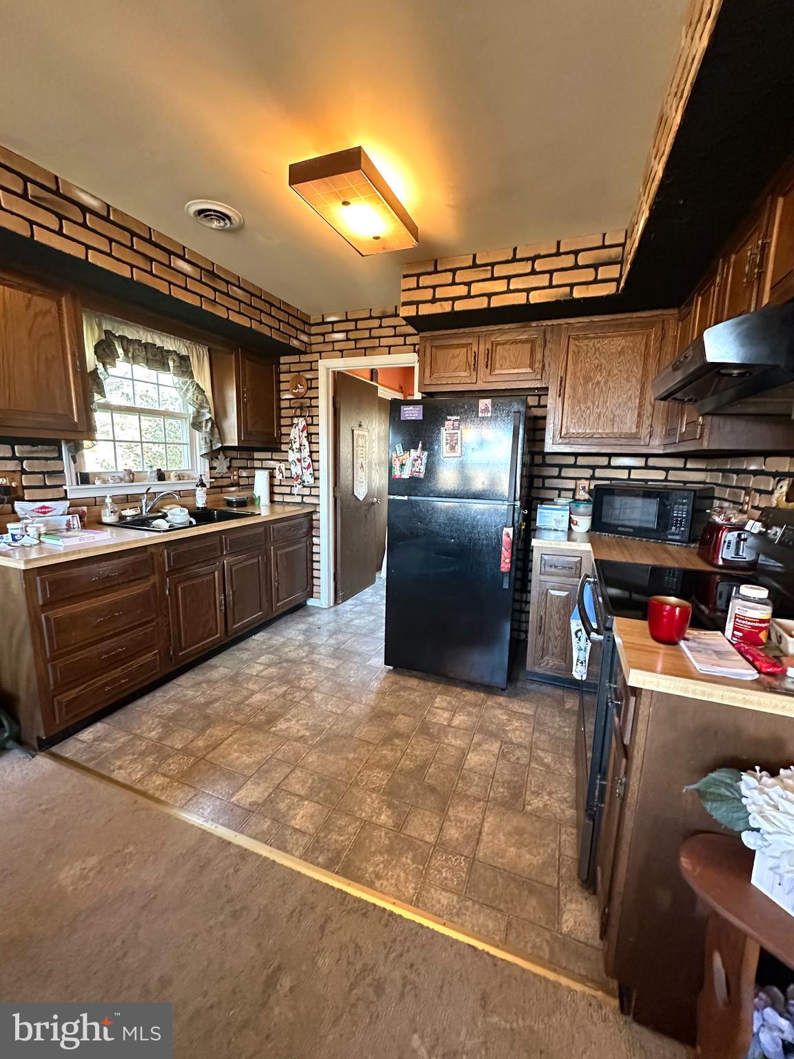 3203 Mannerchor Road Temple, PA 19560 - Photo 7 of 15 a kitchen with refrigerator and window