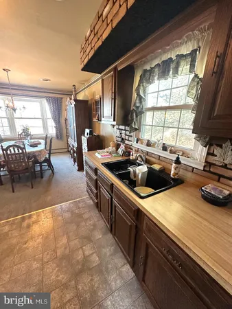 a kitchen with lots of counter top space and furniture