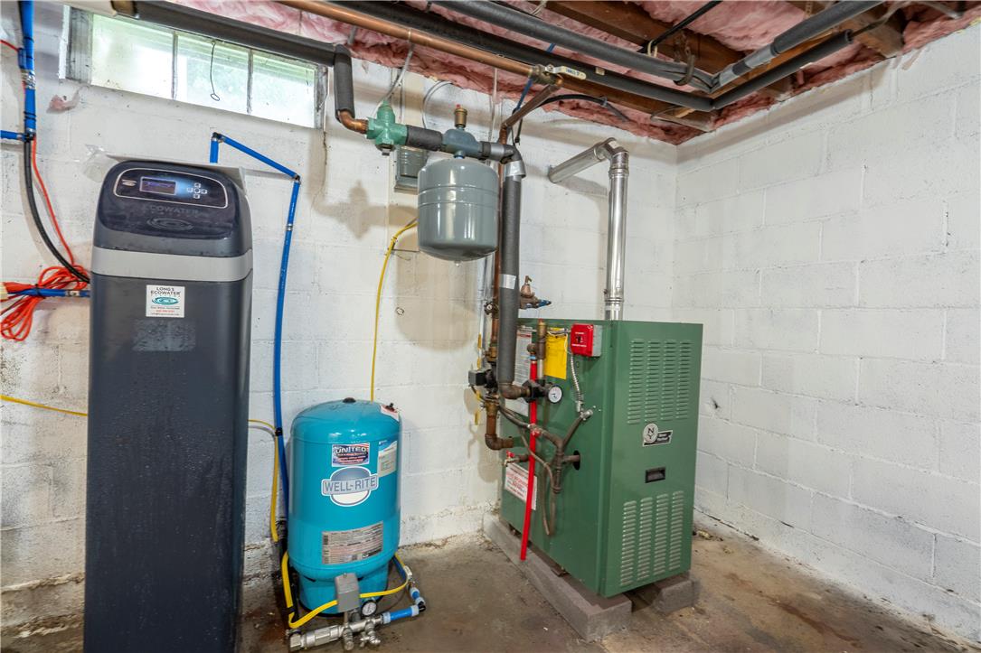 665 Point Phillips Road Bath, PA 18014 - Photo 43 of 73 Essential utility room with water treatment system, water heater, and a window for ventilation.