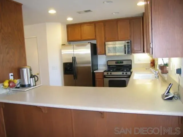 a kitchen with a refrigerator and a sink