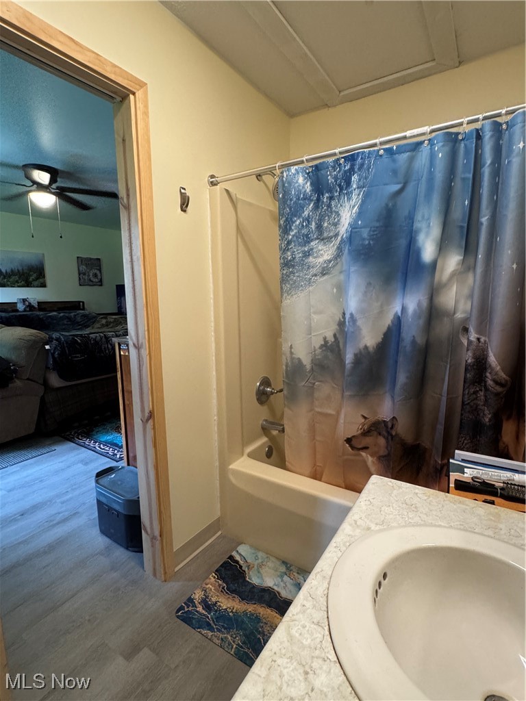 71322 Sharon Road Bridgeport, OH 43912 - Photo 20 of 39 Bathroom featuring shower / tub combo with curtain, wood finished floors, vanity, and a ceiling fan
