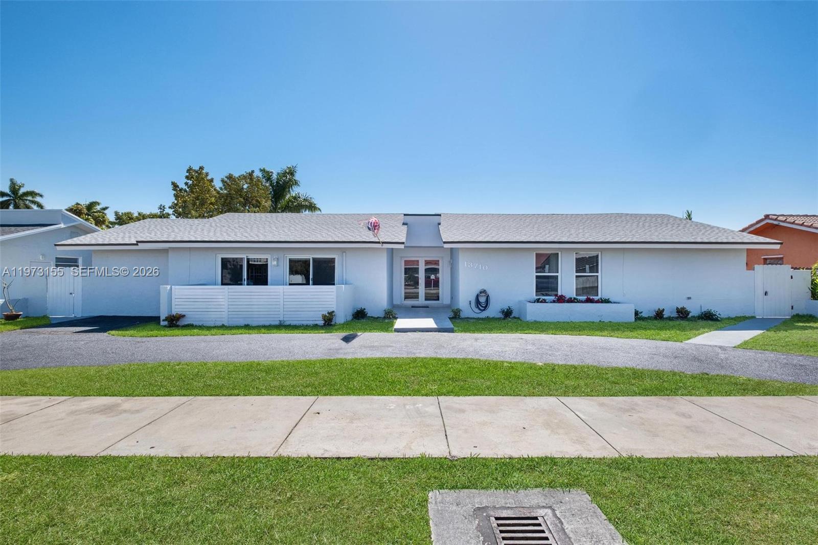 13710 Southwest 18th Terrace Miami, FL 33175 - Photo 1 of 46 a front view of a house with a yard