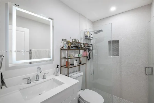 a bathroom with a sink toilet and shower