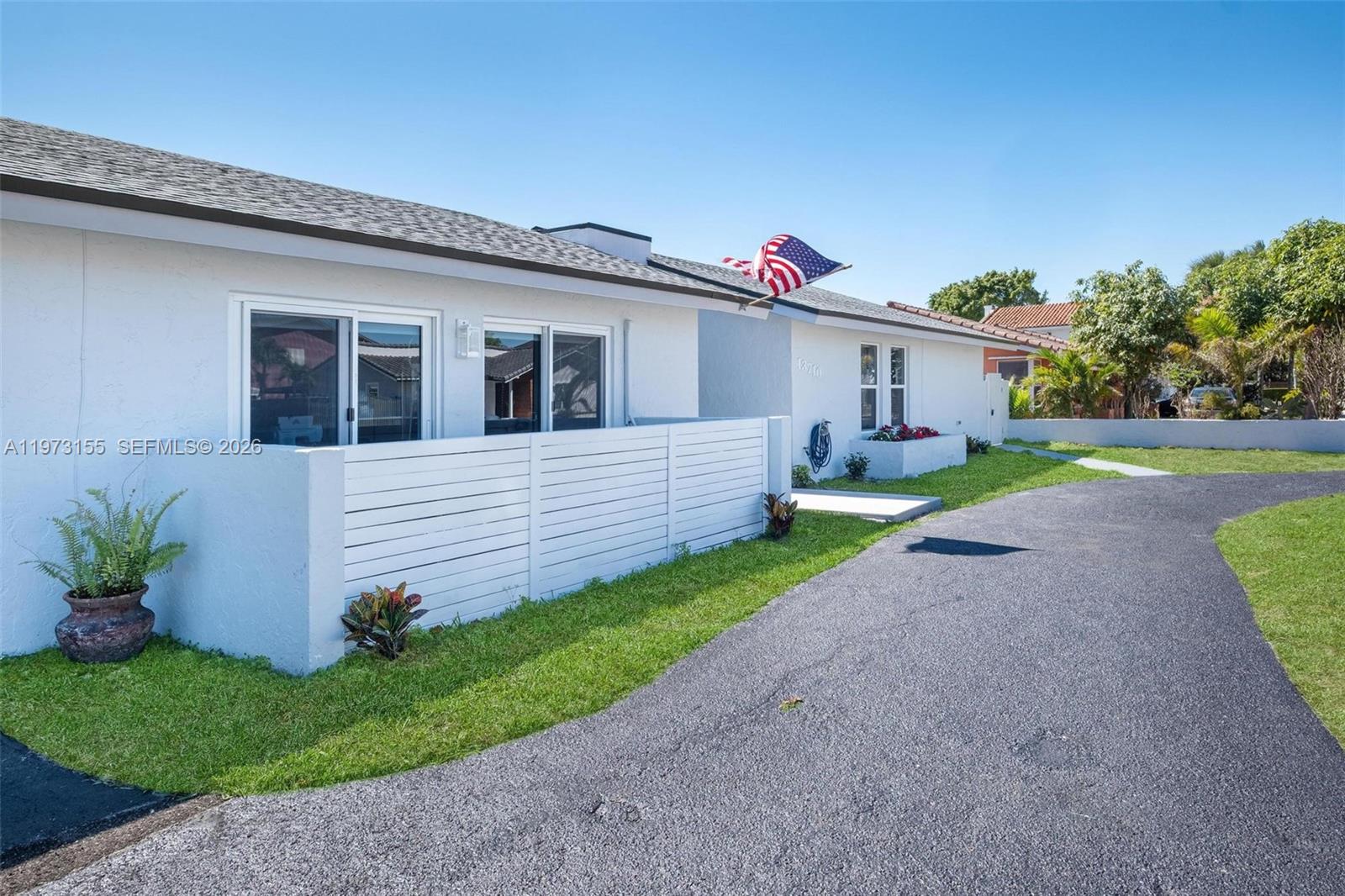 13710 Southwest 18th Terrace Miami, FL 33175 - Photo 2 of 46 a front view of a house with garden