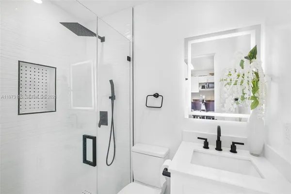 a bathroom with a shower and a sink