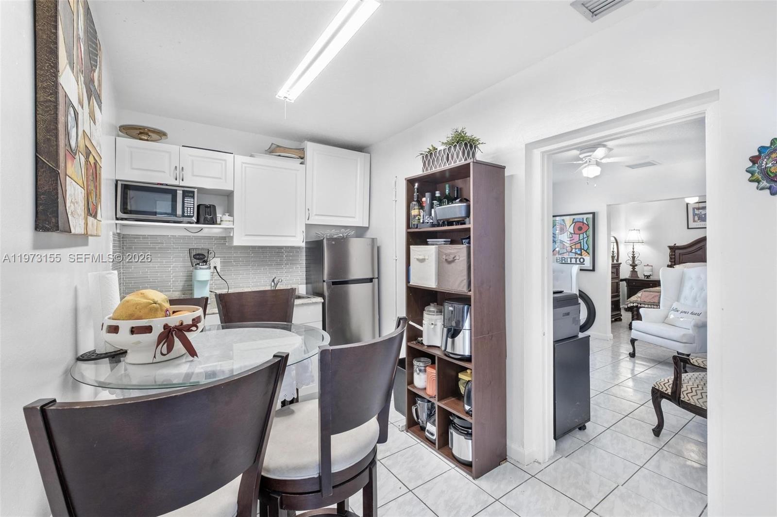 13710 Southwest 18th Terrace Miami, FL 33175 - Photo 22 of 46 a kitchen with a dining table and chairs