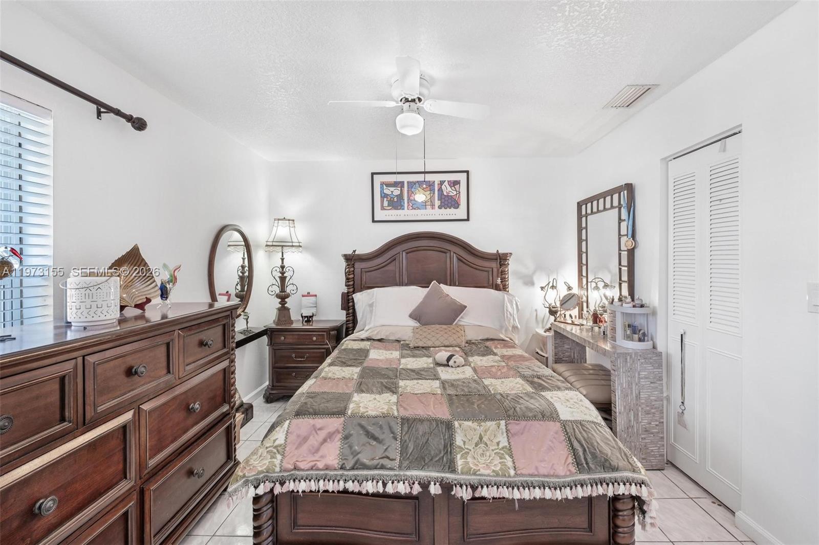 13710 Southwest 18th Terrace Miami, FL 33175 - Photo 26 of 46 a bedroom with a bed and a dresser with the mirror