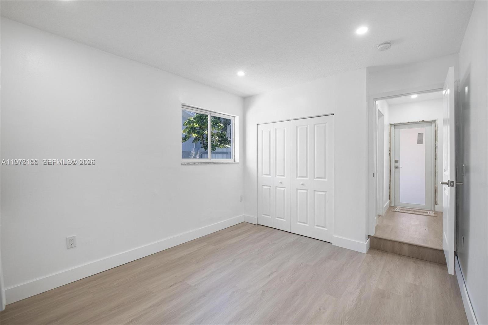 13710 Southwest 18th Terrace Miami, FL 33175 - Photo 29 of 46 an empty room with wooden floor and windows