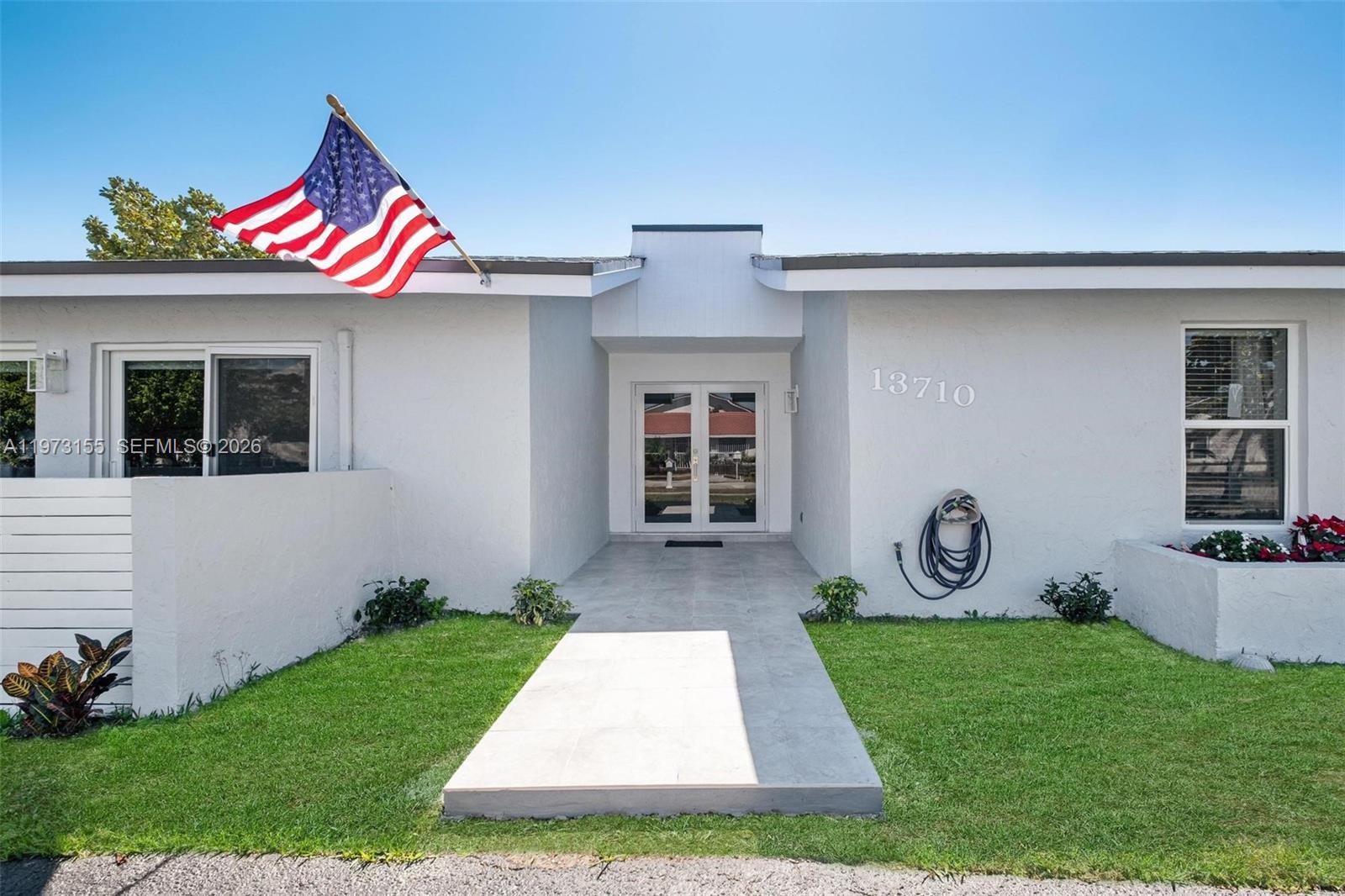 13710 Southwest 18th Terrace Miami, FL 33175 - Photo 3 of 46 a front view of a house with garden