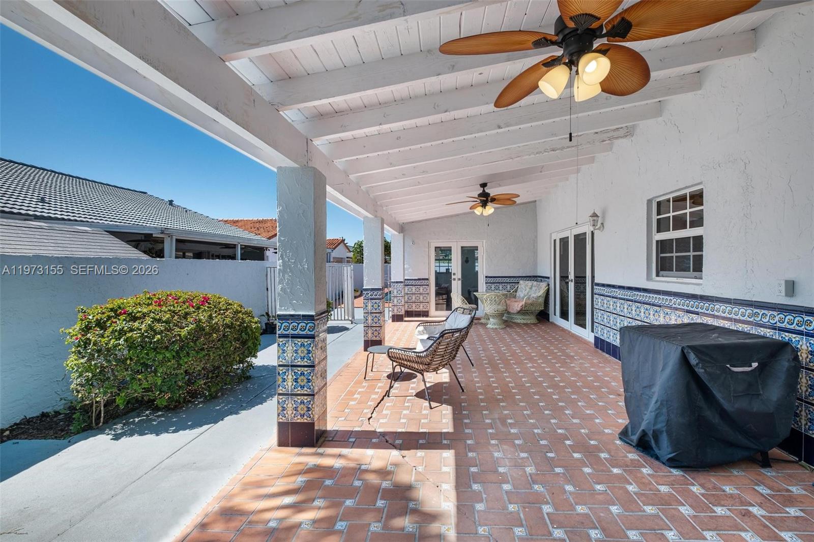 13710 Southwest 18th Terrace Miami, FL 33175 - Photo 31 of 46 a living room with patio furniture and a fireplace